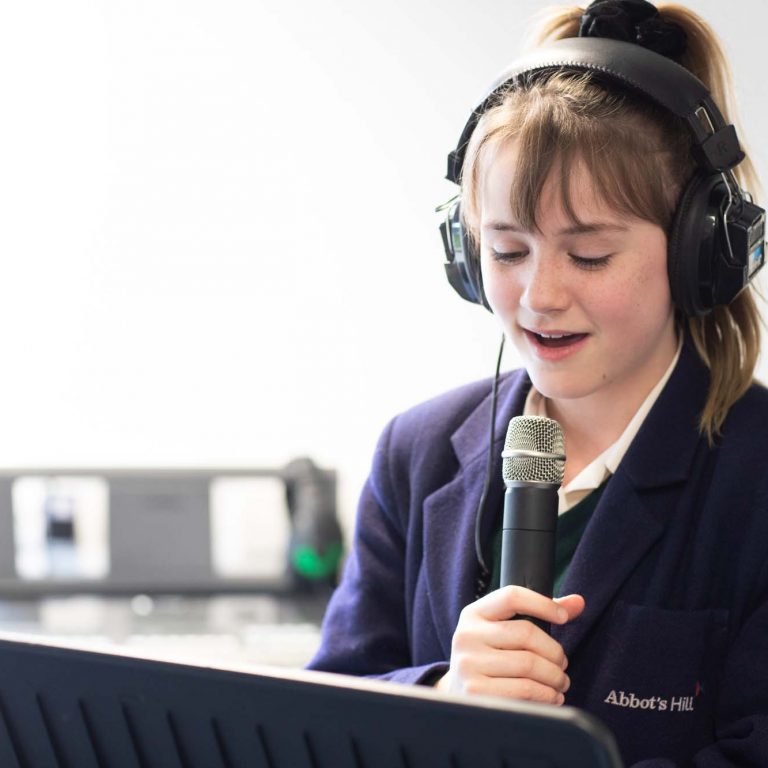 girl singing into a microphone