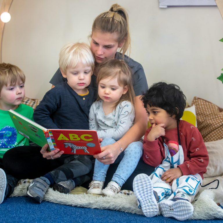 teacher reading to young children