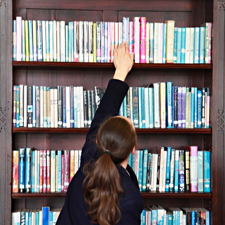girl reaching for a book