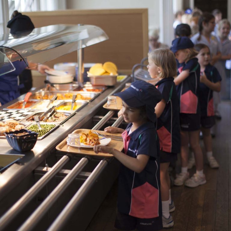 children with trays of food